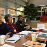 Mary, Steve, and Sonja laugh at a joke during the meeting