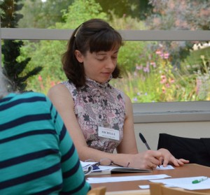 Members write feedback for speakers.