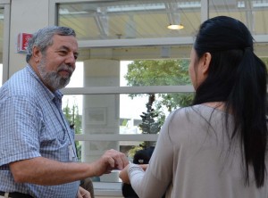 Junlei presents a song title to Mike for Table Topics.