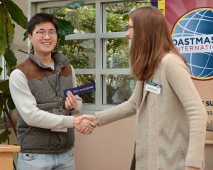 Nicole awards Shen a ribbon as best evaluator.